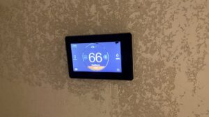 A modern smart thermostat displaying temperature settings, installed by The HVAC Doc in Rock Springs, WY