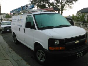 The professional service van for Smith Electrical Contractors, Inc. parked on a street in El Cajon, CA.