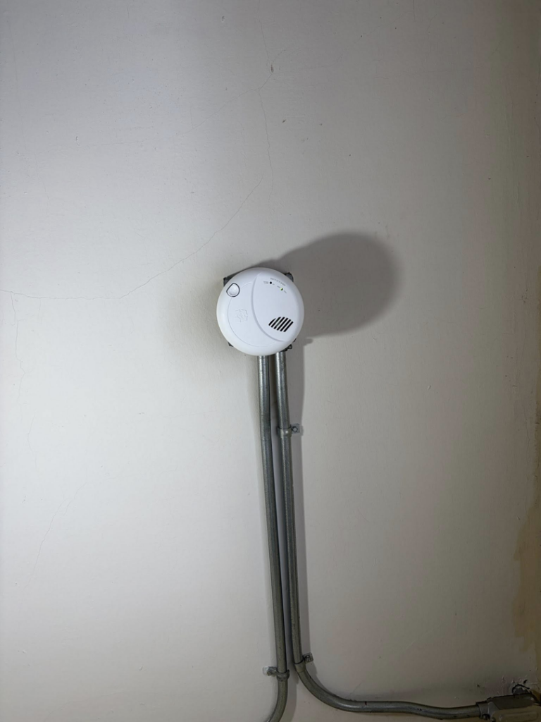 A smoke detector installed with electrical conduit by Dartmouth Fire Protection Electrical Division in New Bedford, MA.