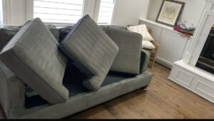 Sofa cushions lifted, preparing for professional upholstery cleaning service by Carpet Cleaners Plus in Chicago, IL.