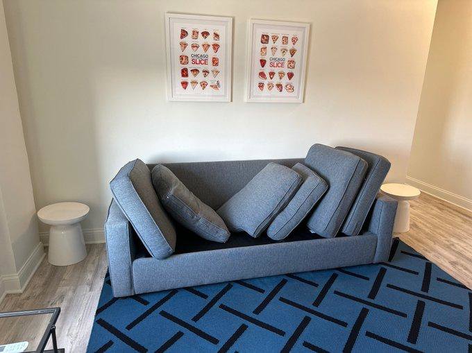 A sofa with cushions removed on an area rug, part of a cleaning service by Anderson Certified, INC. in Chicago, IL.