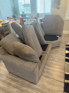 Sofa cushions removed and stacked, preparing for professional upholstery cleaning by Proper Carpet Cleaning in Aurora, IL.