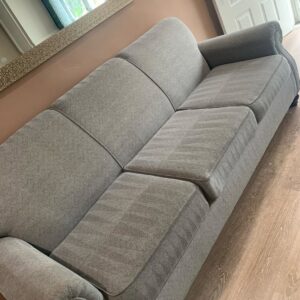 Sofa upholstery showing distinct cleaning lines after professional cleaning by Central California King of Clean LLC in Bakersfield, CA.