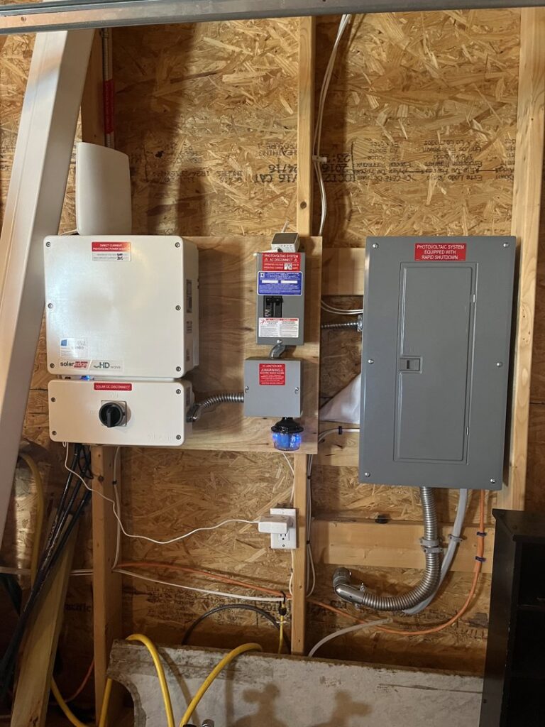 Solar electrical panel and inverter wiring installed on a wall by Russell Electric LLC in Saint Clair, MI