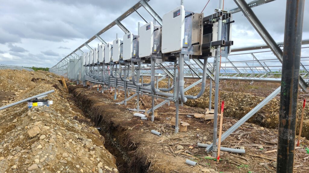 Electrical conduits and equipment being installed in a trench for a solar farm project by Premier Electric LLC in Palmer, AK.