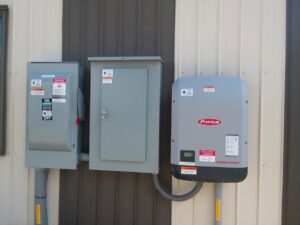 A Fronius Primo solar inverter and electrical panels installed by All Circuit Electrical LLC on a building in Bryant, IN.