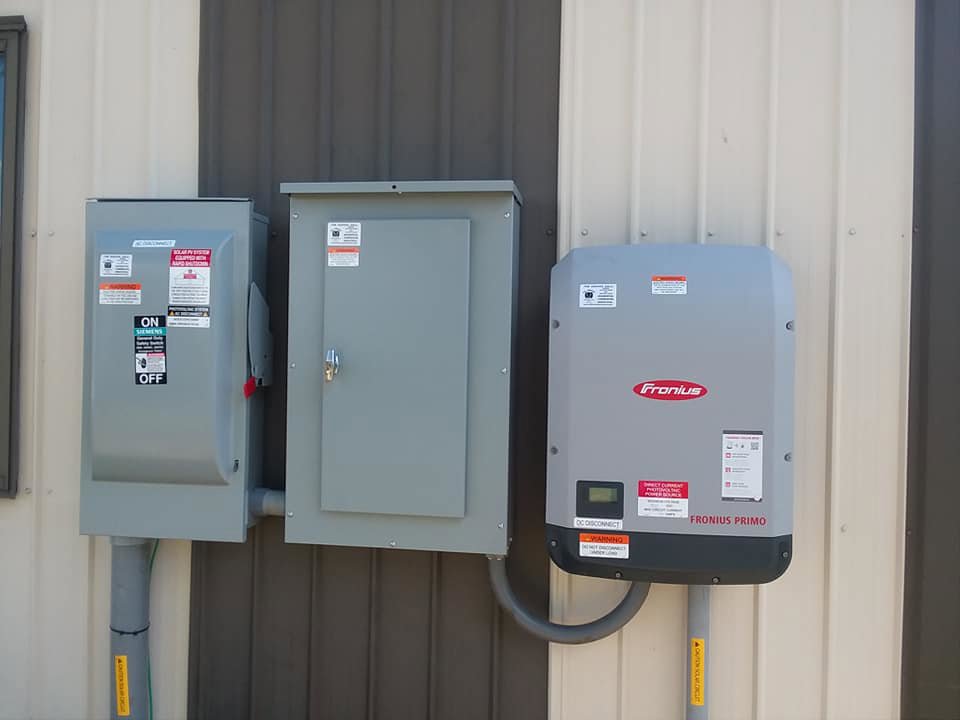 A Fronius Primo solar inverter and electrical panels installed by All Circuit Electrical LLC on a building in Bryant, IN.