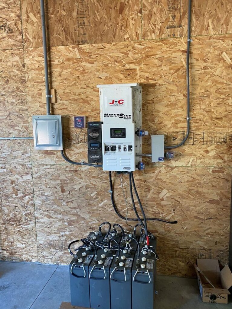 Solar inverter, charge controller, and battery bank installed on a wall by J C Electric & Solar in Lewiston, ID