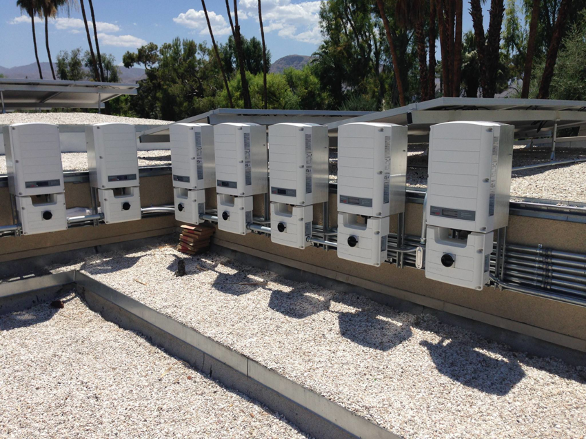 Multiple solar inverters installed on a rooftop, showcasing electrical work by FVVElectric Services in Anaheim, CA