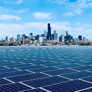 A large-scale solar panel installation with the Chicago skyline in the background, a project type handled by MKD Electric in Elgin, IL.