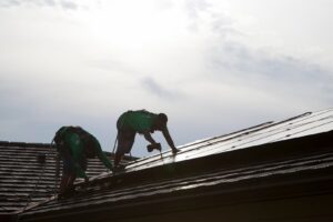 Solar panel installation in progress by electricians from Alternate Energy Inc. on a residential roof in Pearl City, HI.