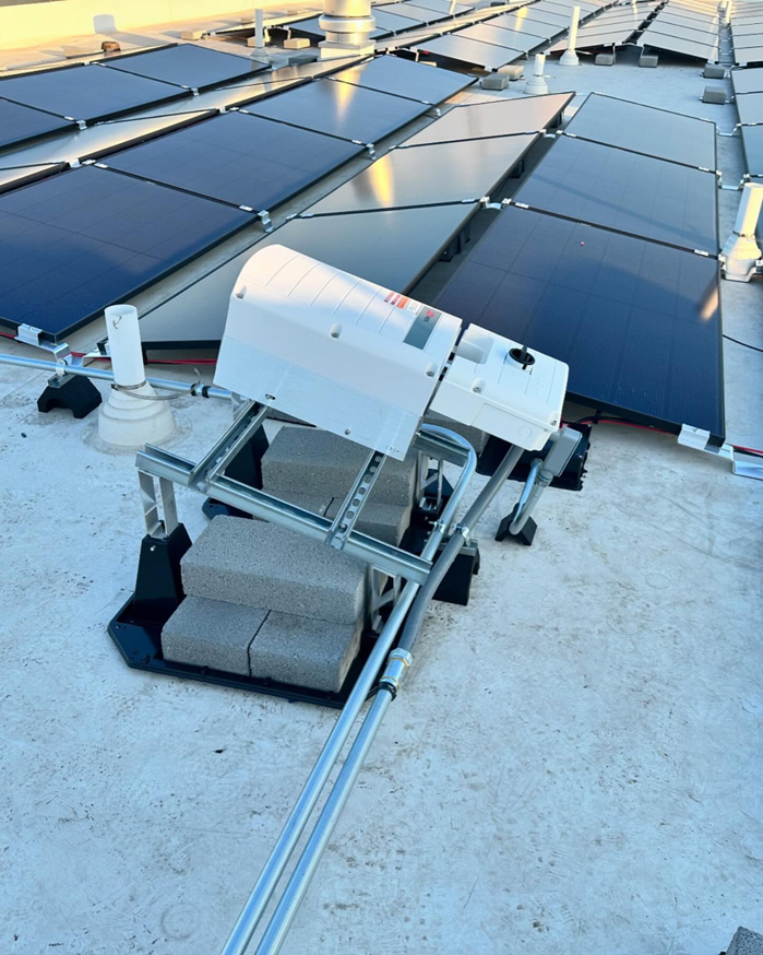 Solar panel inverter and electrical conduit installation on a rooftop by Revamp Electric LLC in Columbus, OH.