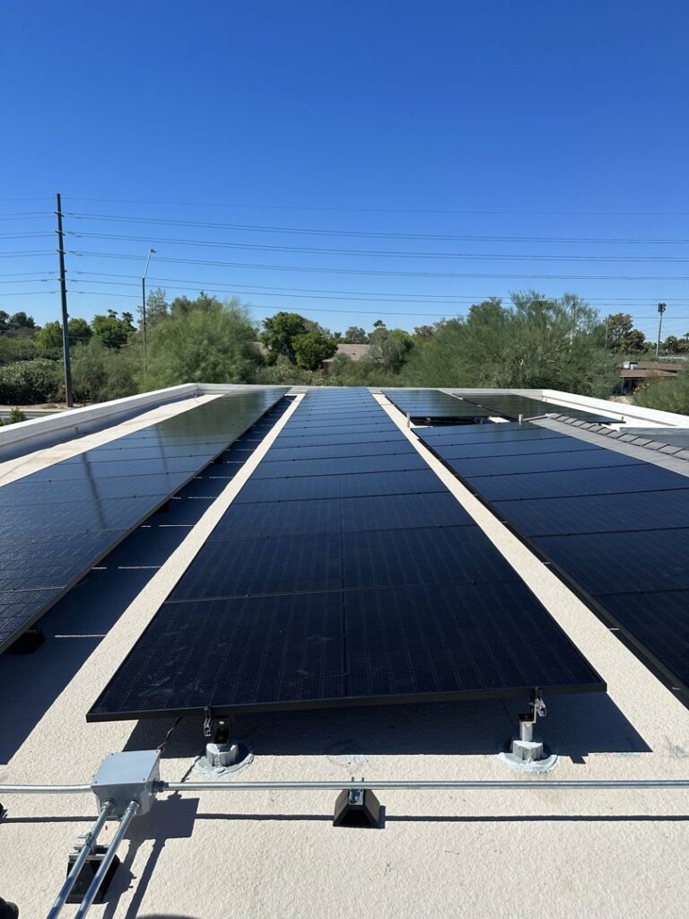 A completed solar panel system with visible electrical conduits on a flat roof installed by Modern Day Energy in Phoenix, AZ