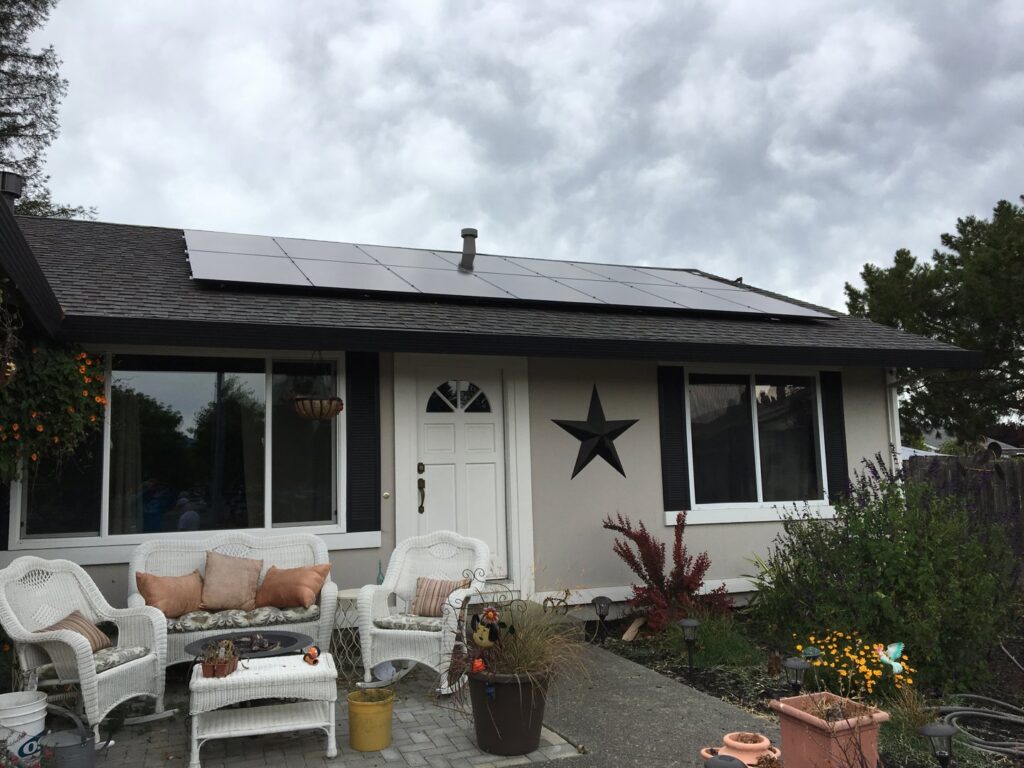 Solar panels expertly installed on a roof, positioned around a chimney by Solar & Electric Service Bros in West Sacramento, CA.
