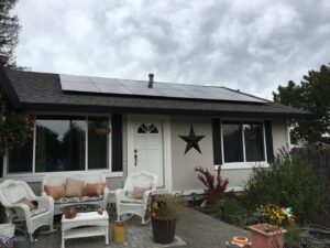 Solar panels expertly installed on a roof, positioned around a chimney by Solar & Electric Service Bros in West Sacramento, CA.