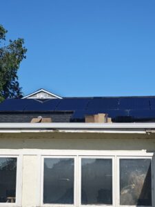 Solar panels being installed on a residential rooftop, showing the installation process by Pueblo Electrics, Inc. in Pueblo, CO.