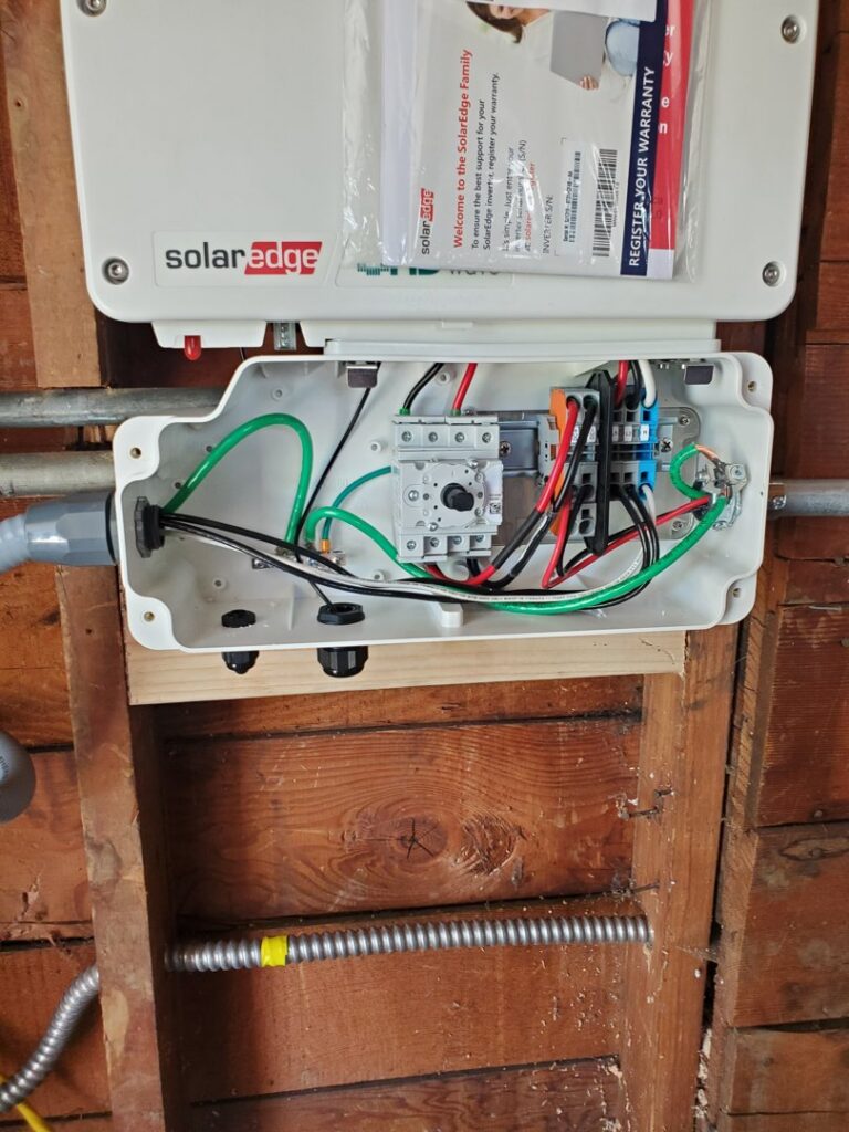 Close-up of a SolarEdge inverter with internal wiring, installed by Johnsen Electric Inc in Springfield, OR.