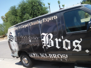 A Solmon Brothers Carpet Cleaning Services van, labeled 'The Valley's Carpet Cleaning Experts,' parked in Glendale, AZ.