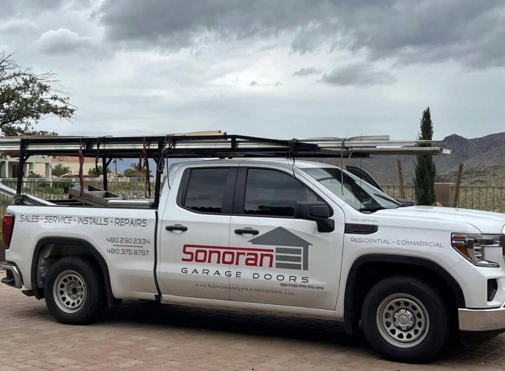 A Sonoran Garage Doors service truck loaded with garage door panels, ready for installation or repair in Mesa, AZ