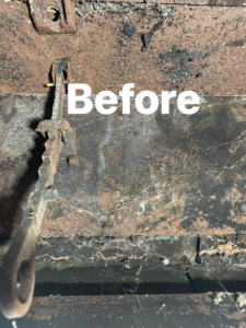 A close-up of a heavily sooty and rusty chimney flue, showing the condition before cleaning by Southern Chimney and Duct Clean in Monroe, LA.