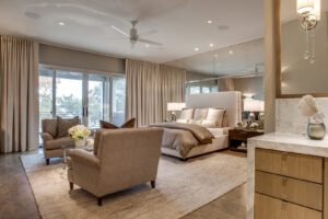 A spacious bedroom featuring a large, light-colored area rug, showcasing the quality products from Dallas Rugs in Dallas, TX.