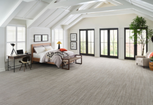 A spacious bedroom with a new light-colored carpet installation by The Carpet Store Tampa, FL