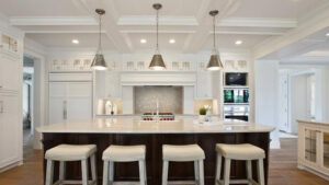 A spacious kitchen showcasing elegant pendant and recessed lighting installed by Daigle Electric in Barrington, NH.