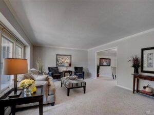 A spacious and elegantly furnished living room featuring a clean, light-colored carpet installed by Floors By Tomorrow in Aurora, CO
