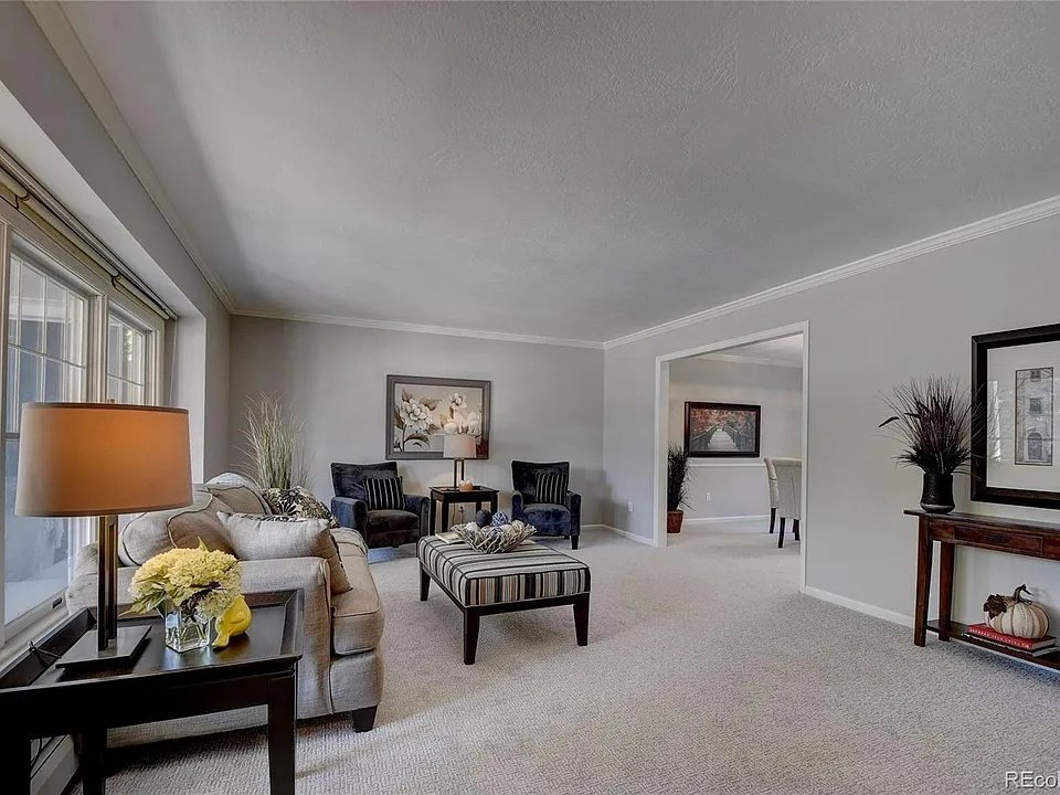 A spacious and elegantly furnished living room featuring a clean, light-colored carpet installed by Floors By Tomorrow in Aurora, CO