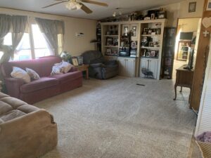 A spacious living room with a clean, light-colored carpet after service by Alamogordo Carpet Cleaning in Alamogordo, NM.