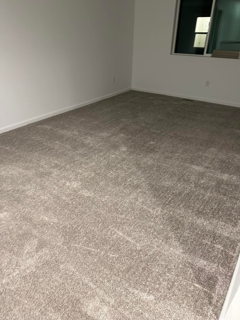 A spacious room with new grey carpet installed by Millennium Flooring .Co in Salt Lake City, UT.