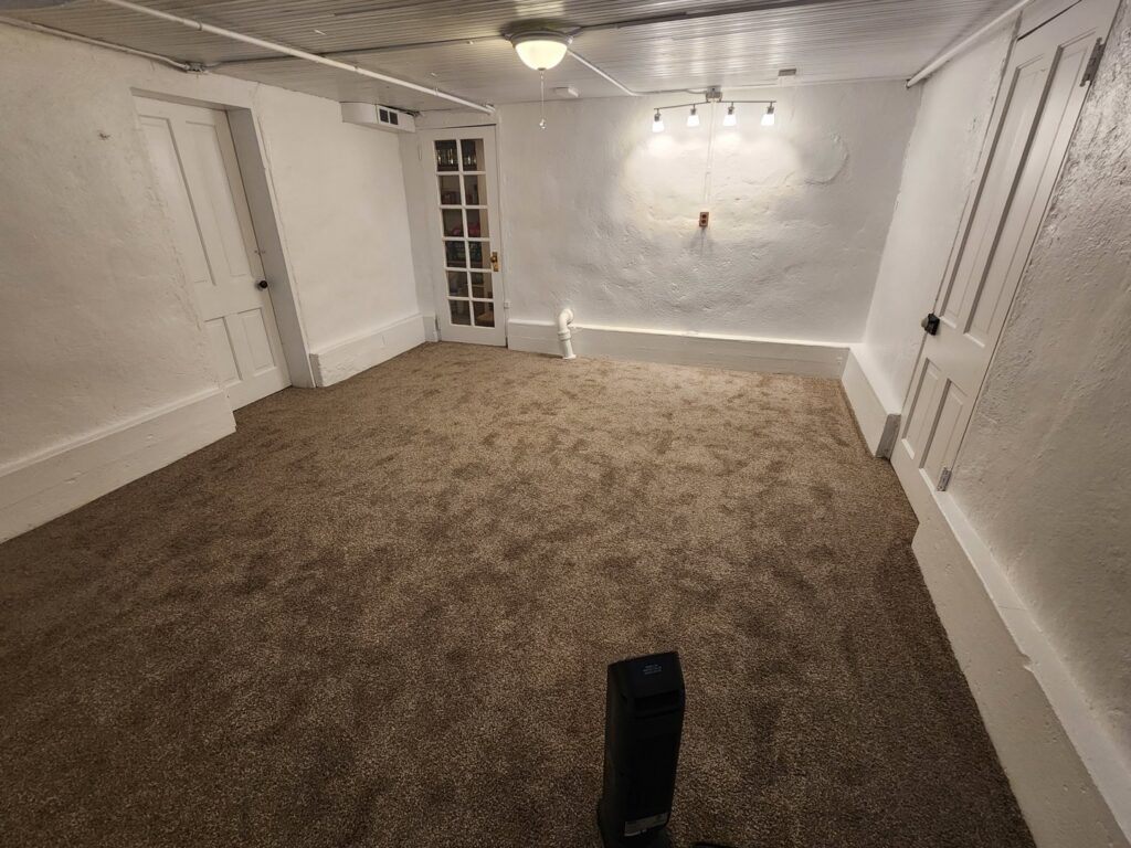 A spacious room showcasing new brown carpet installation by Carpet Clearance Warehouse Pueblo, CO.