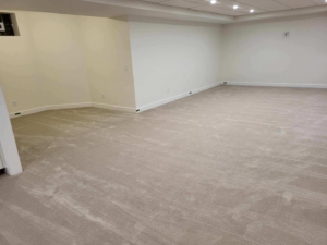 A spacious room showcasing a new beige carpet installation by Christie Carpets & Blinds in Rochester, NY