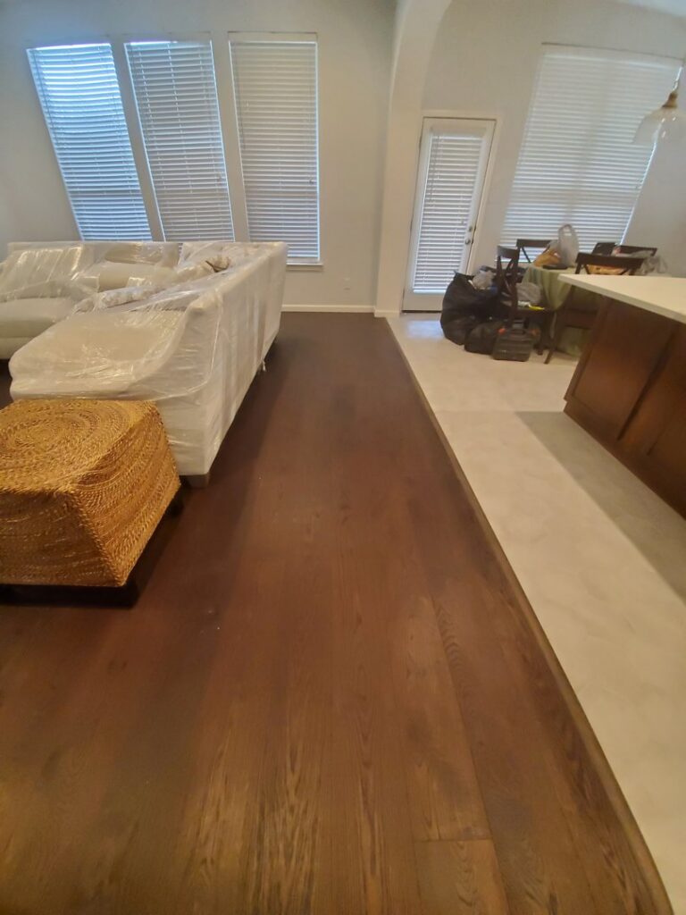A spacious room featuring newly installed beige carpet by Maple Floors in Dallas, TX.