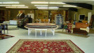 A spacious showroom featuring multiple area rugs and carpet displays at D&D Floors and Moore in Huntsville, AL
