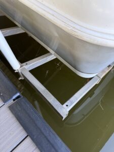 Spiderwebs and insects visible on a boat lift structure, indicating pest activity for EcoShield Pest Solutions Fort Worth, TX.