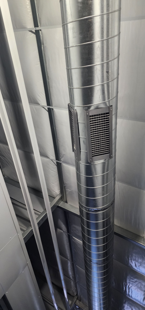 Spiral ductwork with grilles installed on a ceiling, showcasing HVAC work by Jv Services inc. in Pinellas Park, FL.