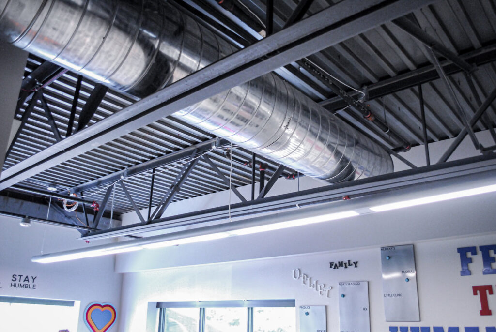 Exposed spiral HVAC ductwork and structural elements in a commercial ceiling, installed by Air-Flow Mechanical Services, Inc. in Cincinnati, OH.
