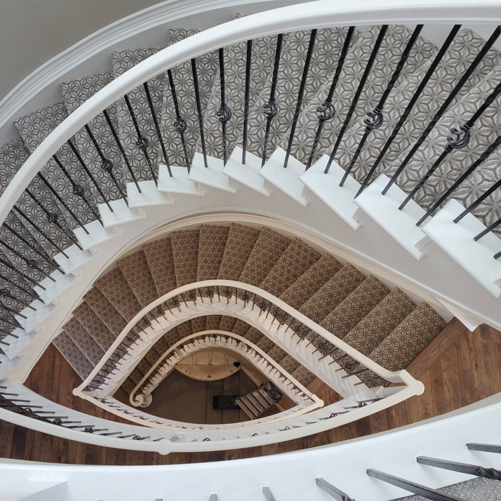 A beautifully installed carpet runner on a spiral staircase by A Floor For You, a carpet contractor in Denver, CO.