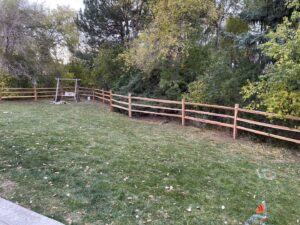 A rustic split-rail fence lining a spacious backyard, expertly installed by North CO Fence & Deck in Greeley, CO.