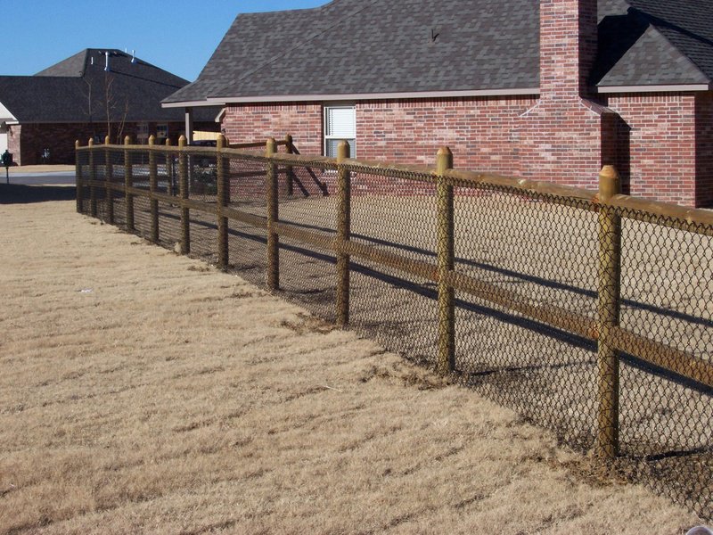 A rustic split-rail fence with wire mesh for added security, installed by D-Fence of Tulsa in Tulsa, OK.