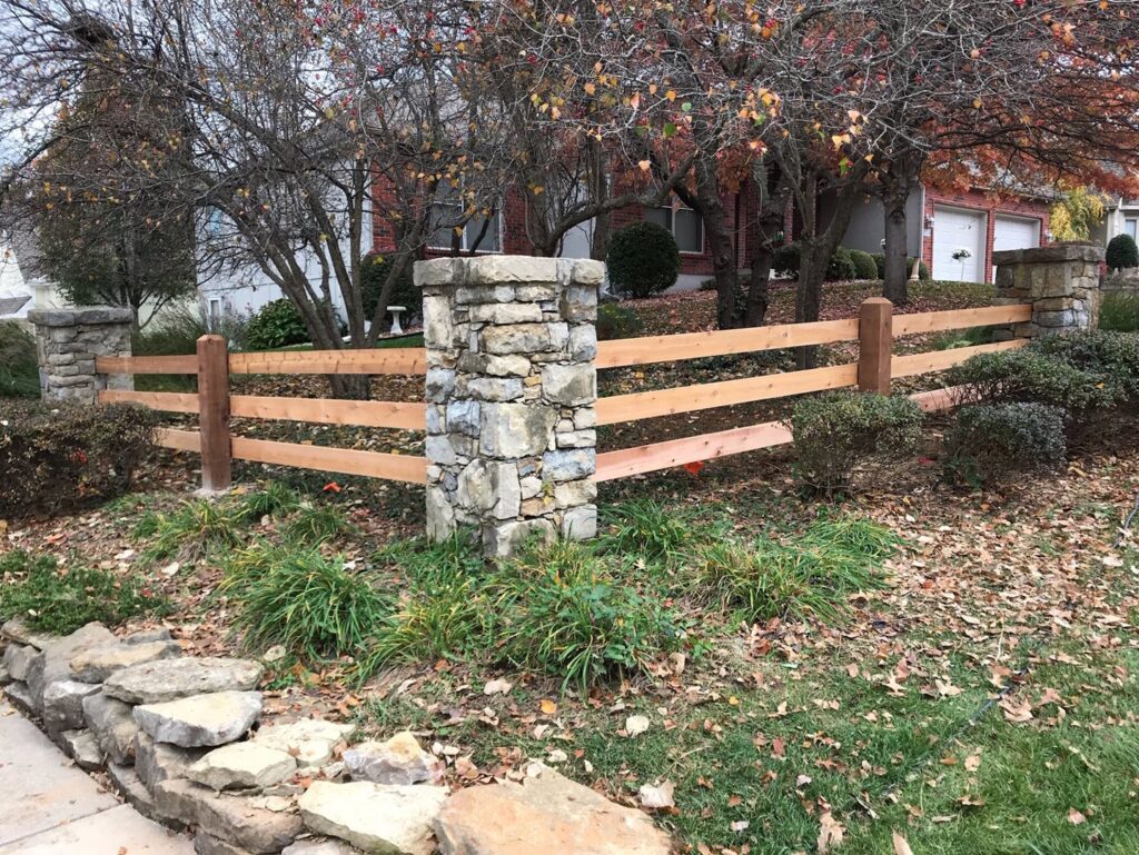 A decorative split rail fence with stone pillars installed by Roy & Son Fencing in Lee's Summit, MO.