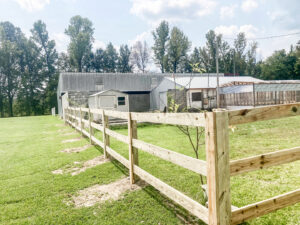 A newly installed split rail wood fence on a rural property by Precision Fence in Meridian, MS.