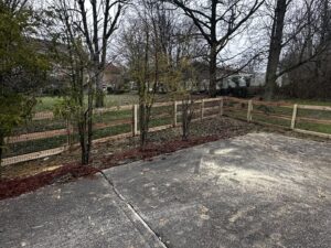 A newly installed split-rail wood fence with wire mesh by Superior Fence & Rail of Northern Kentucky in Florence, KY.