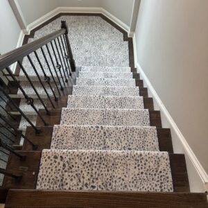 A unique spotted pattern carpet runner installed on a staircase and landing by Carpet Binding Company in Charlotte, NC.