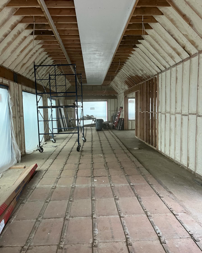 Spray foam insulation applied to attic walls and ceiling by Liquid Green Spray Foam Insulation in Brewster, NY