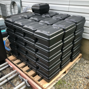 A large stack of black rodent bait stations on a pallet, ready for use by Bayer Pest Control in Dayton, OH.