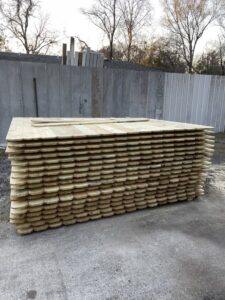 A large stack of new wooden fence pickets, ready for installation by Julien Affordable Fencing LLC in Jacksonville, FL
