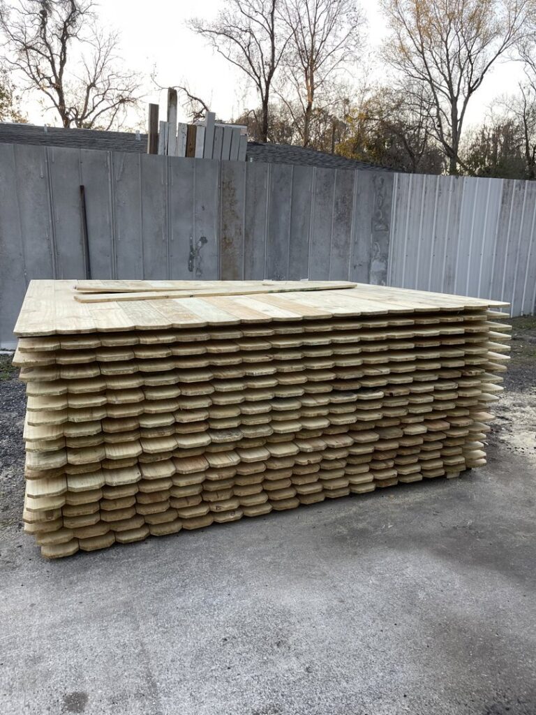 A large stack of new wooden fence pickets, ready for installation by Julien Affordable Fencing LLC in Jacksonville, FL
