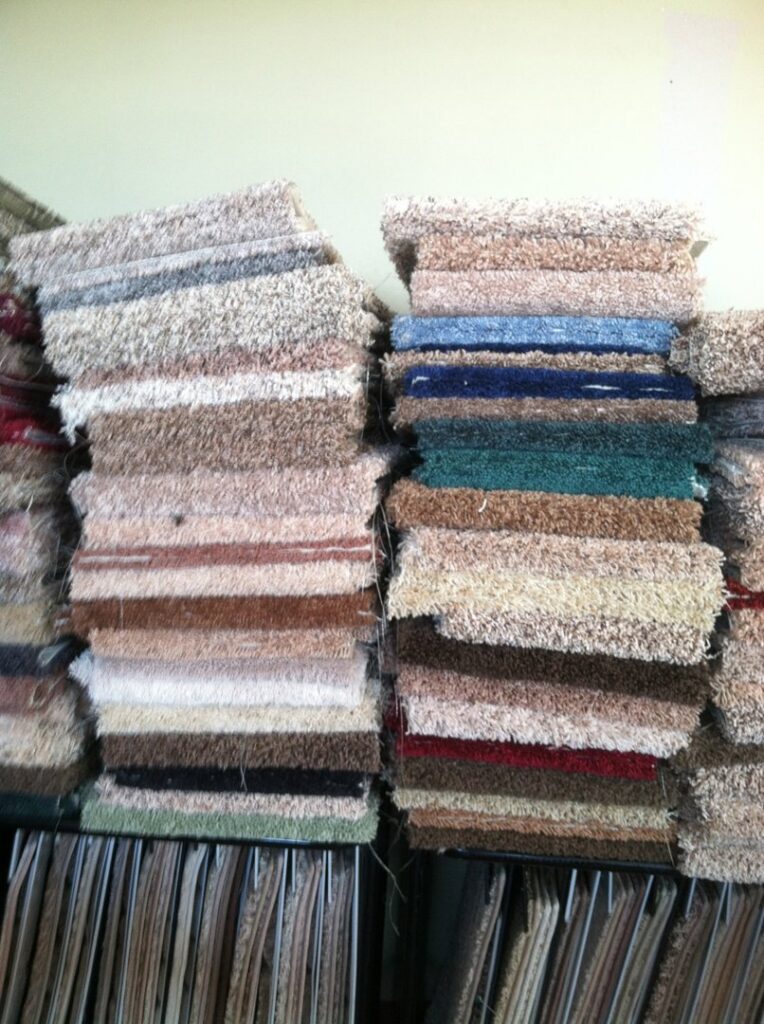 Stacks of colorful carpet samples showcasing different textures at The Carpet Plaza in Bakersfield, CA